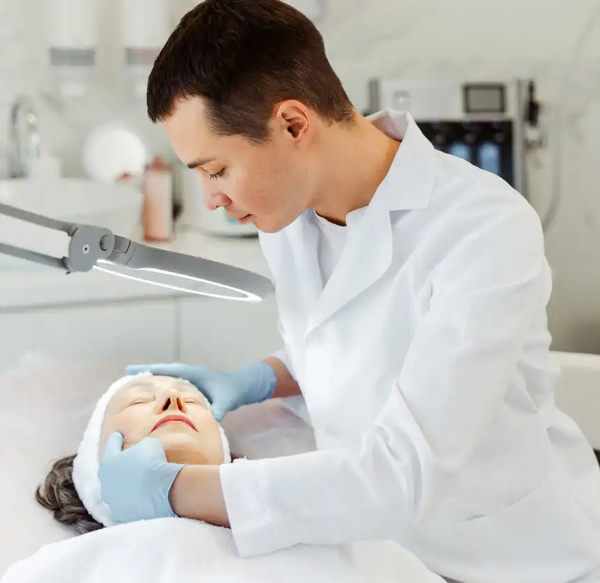 Handsome cosmetologist doctor, beautician man wearing white coat, doing cosmetic procedures